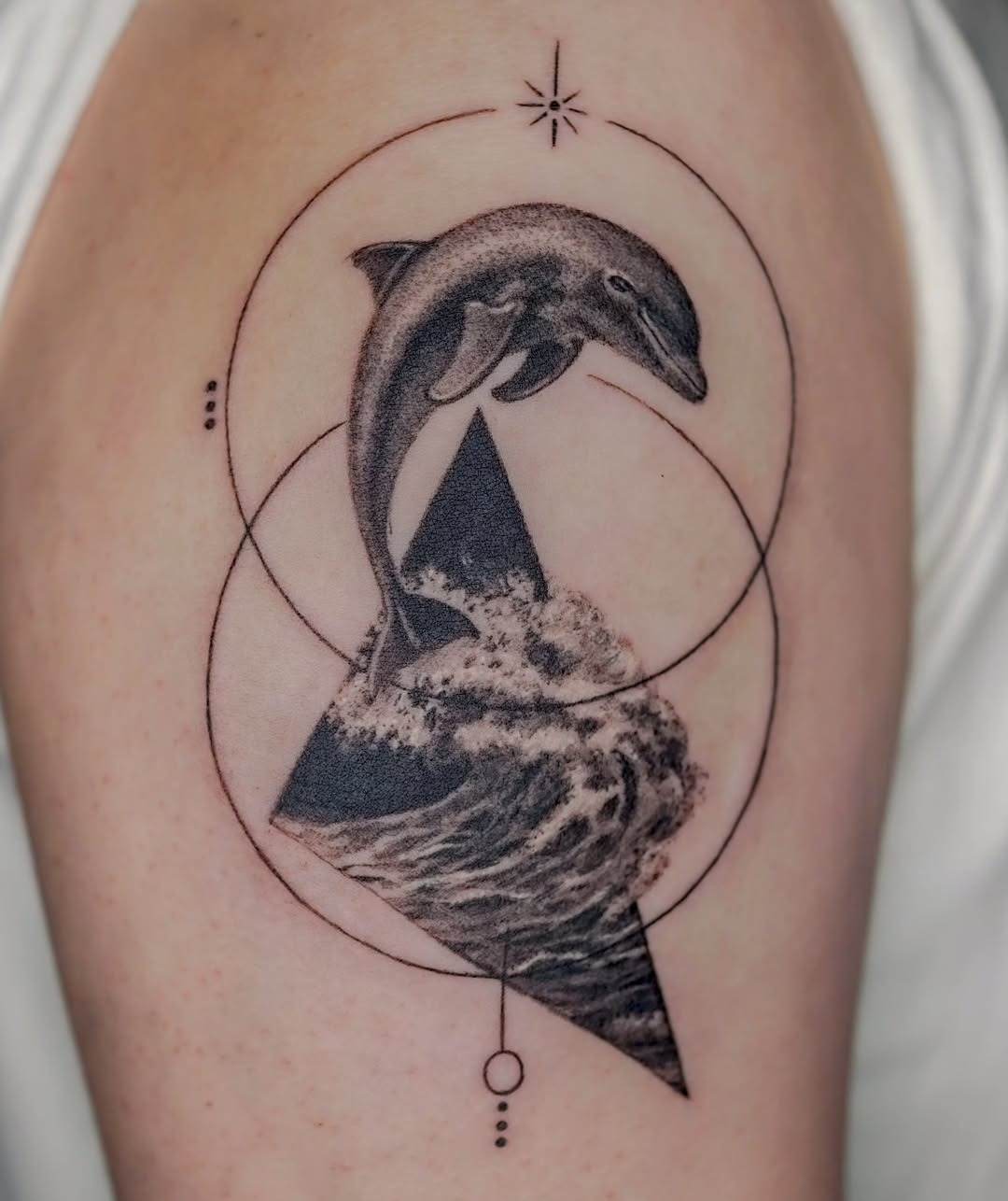 Charming dolphin tattoo with playful ribbons Tattoo Design