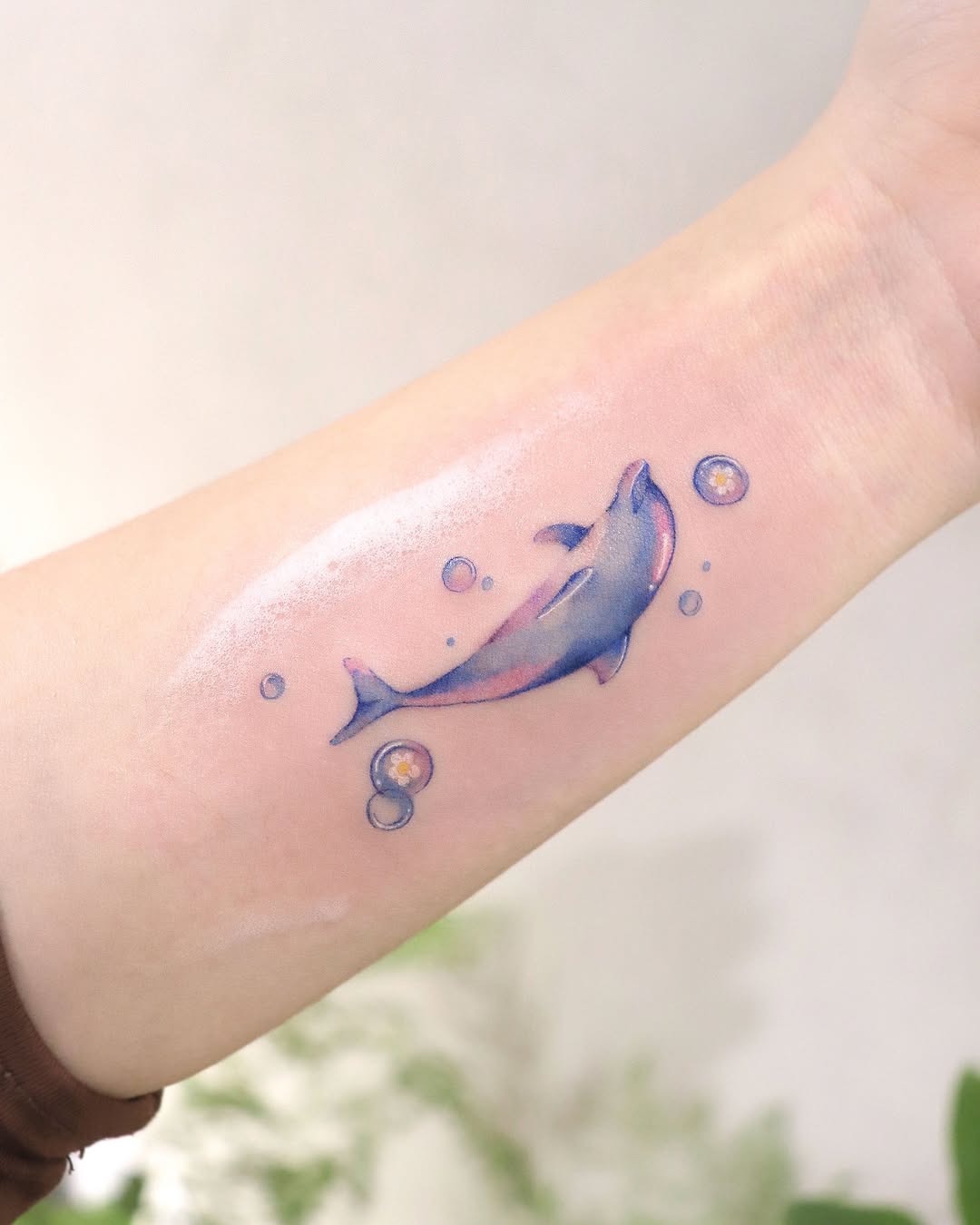 Colorful dolphin tattoo with rose detail Tattoo Design