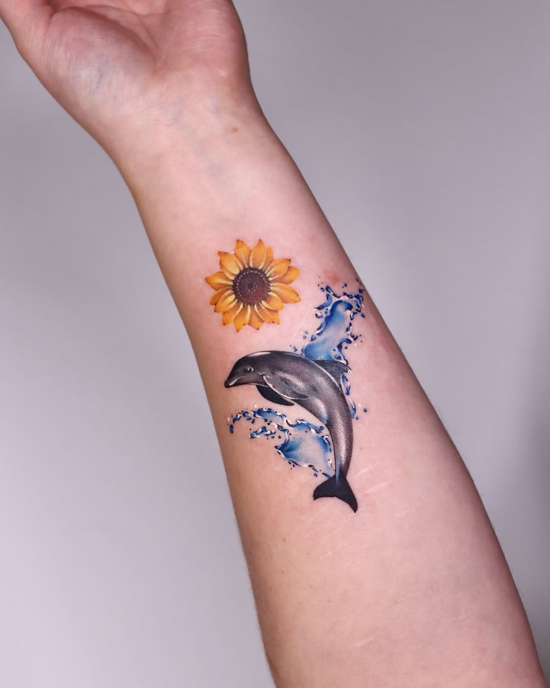Elegant dolphin tattoo with flowing waves Tattoo Design
