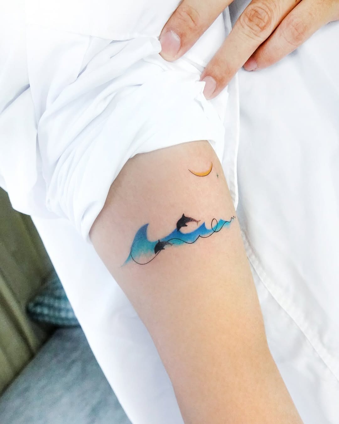 Elegant dolphins dancing in ocean waves Tattoo Design