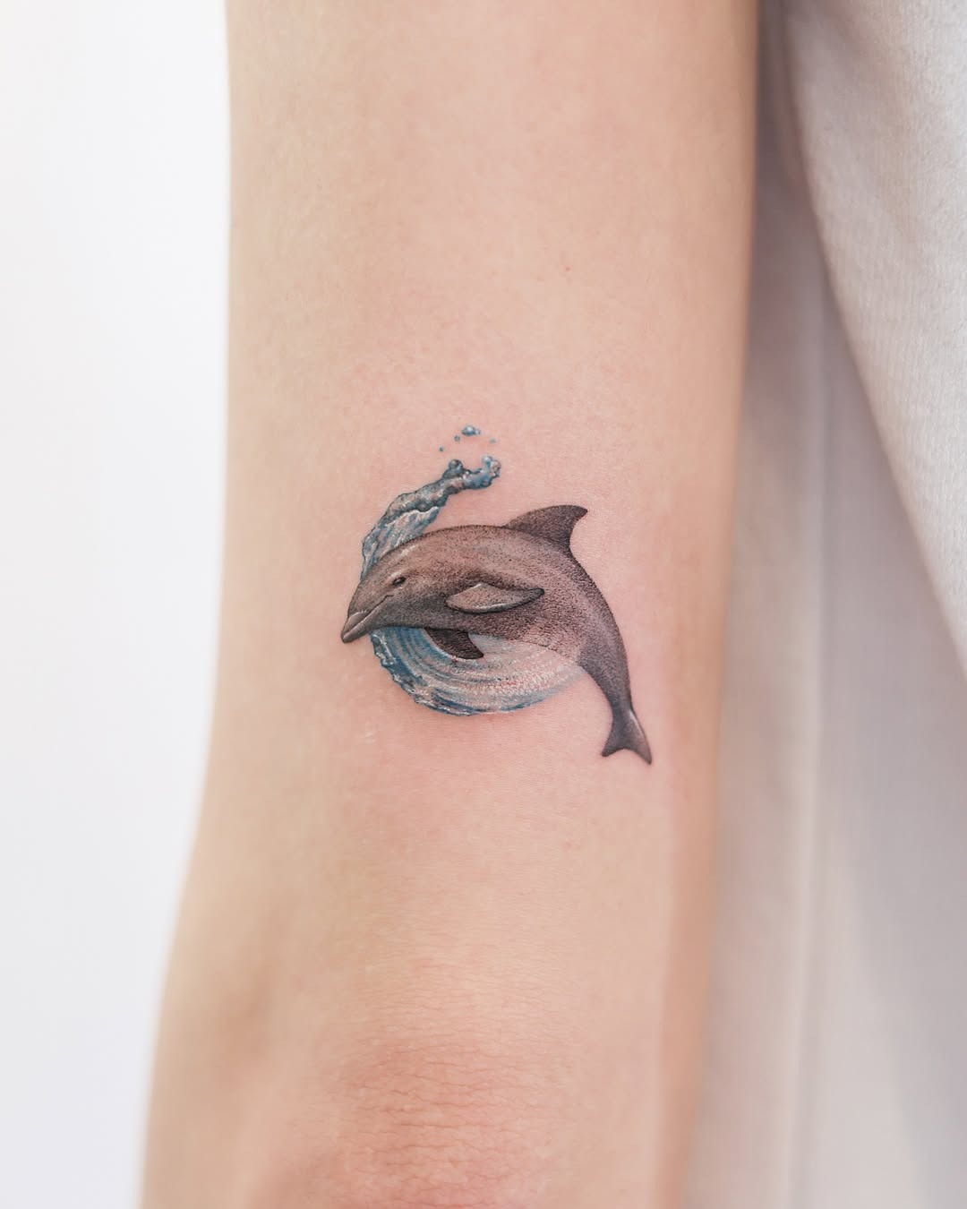 Elegant realistic dolphin tattoo with water splash Tattoo Design