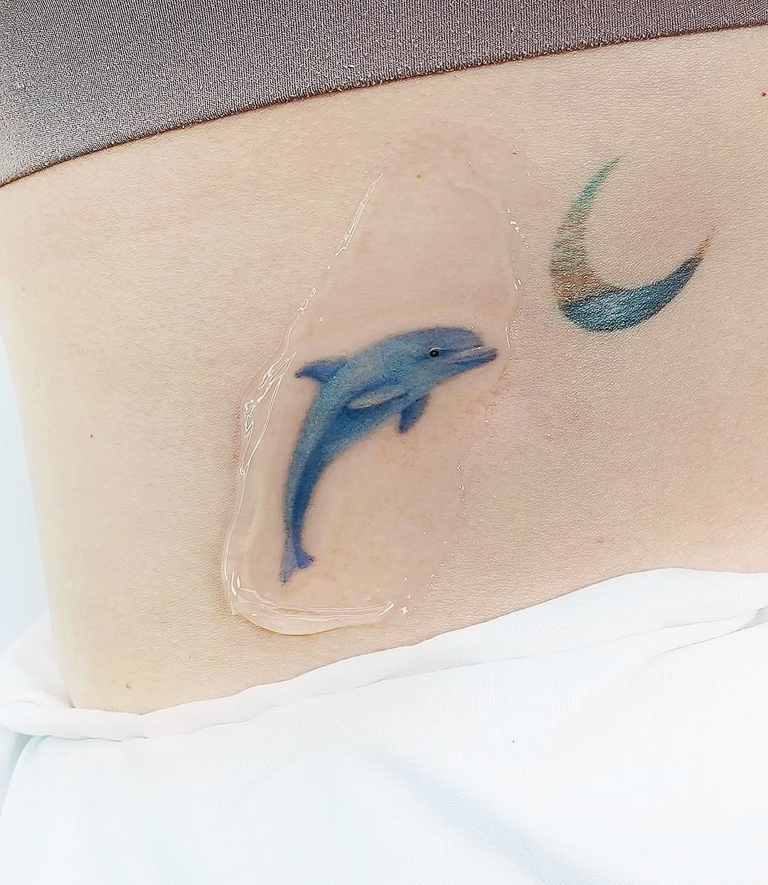 Minimalist Dolphin Tattoo on the Foot Tattoo Design