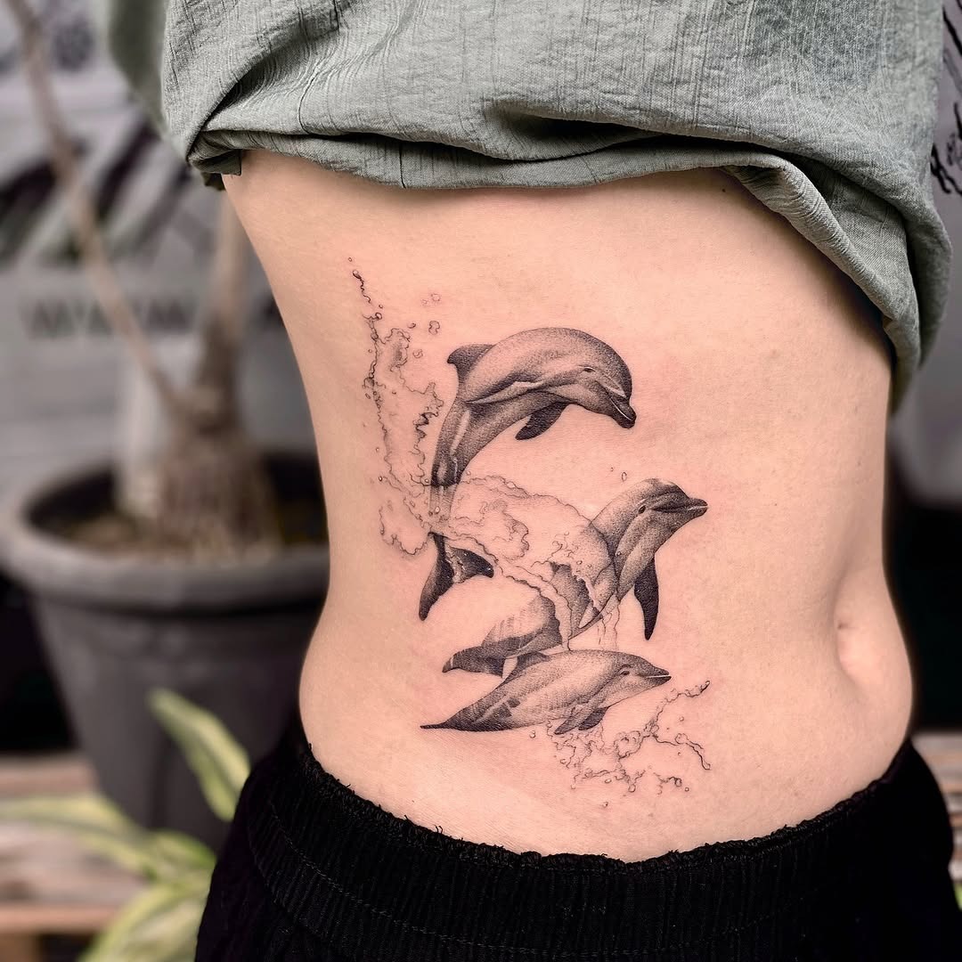Playful dolphin tattoo with colorful splashes Tattoo Design