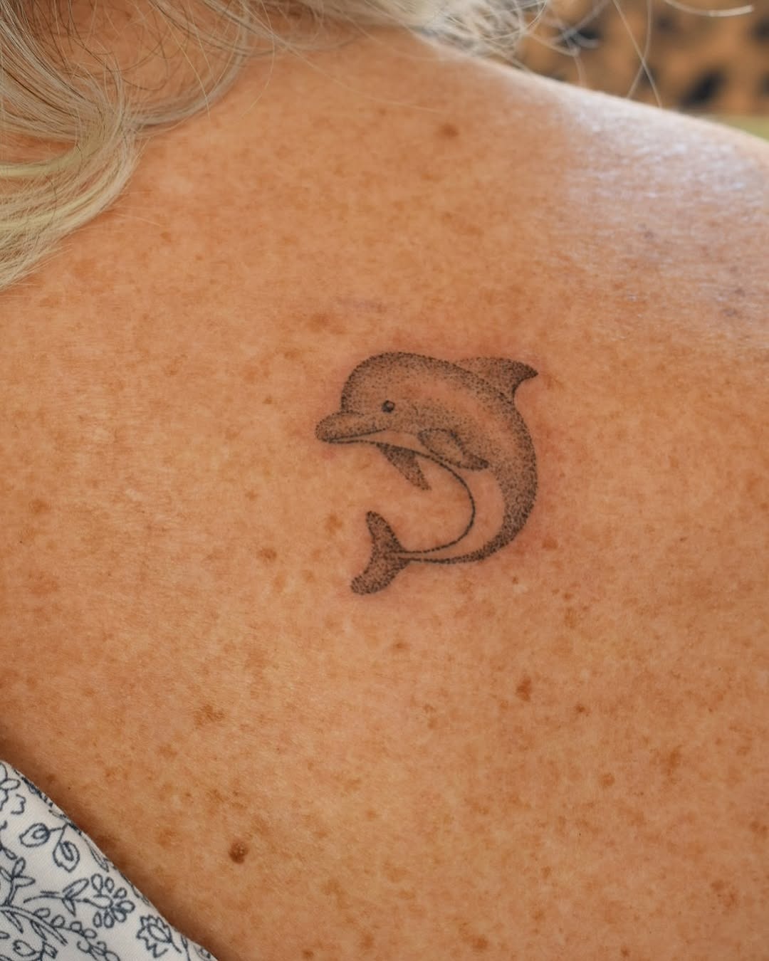 Playful dolphins in vibrant blue waves Tattoo Design