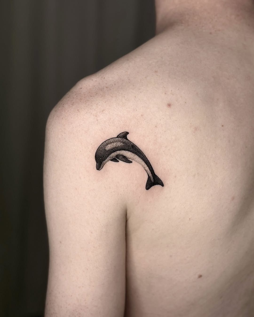 Stunning dolphin tattoo splashing through water Tattoo Design