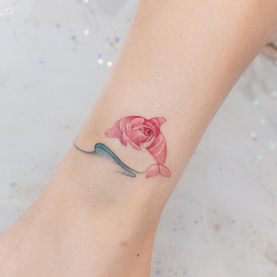 Stylish black dolphin tattoo with star accents Tattoo Design