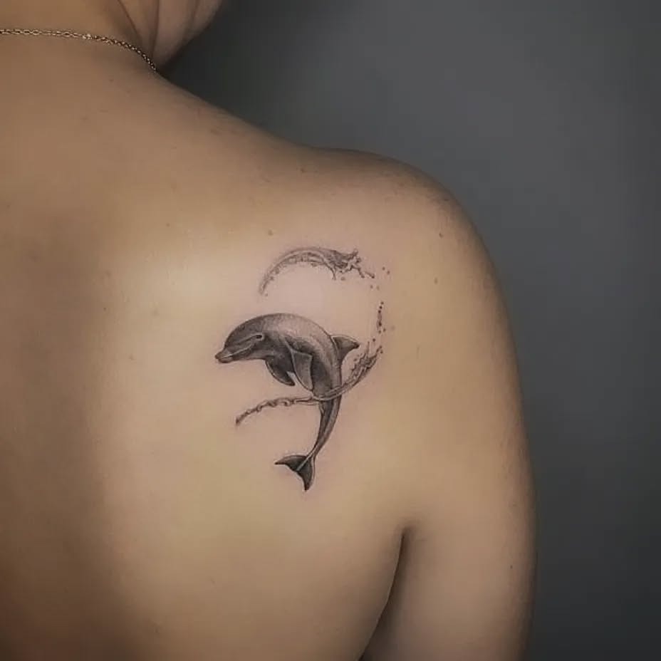 Stylized dolphin tattoo with elegant lettering Tattoo Design