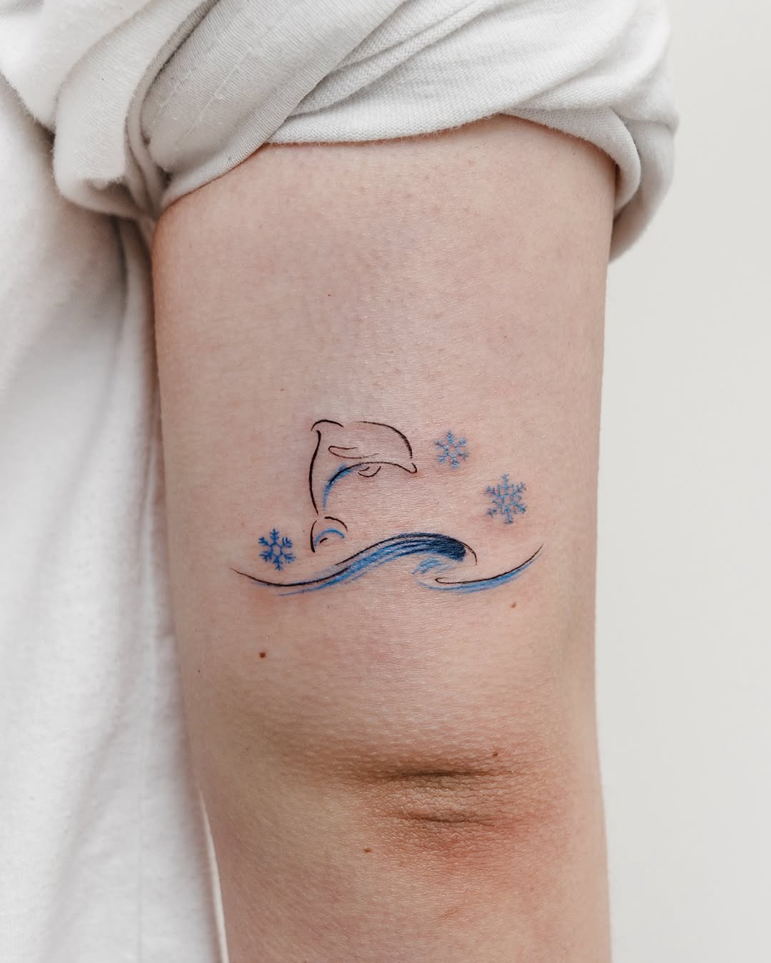 Vibrant dolphin tattoo design on the arm Tattoo Design