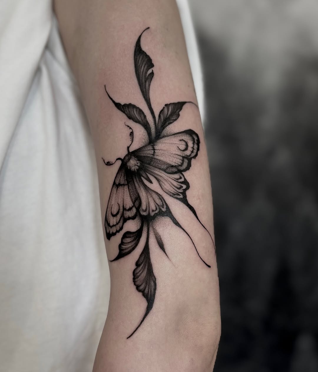This stunning butterfly tattoo utilizes intricate dotwork techniques to create a mesmerizing effect.