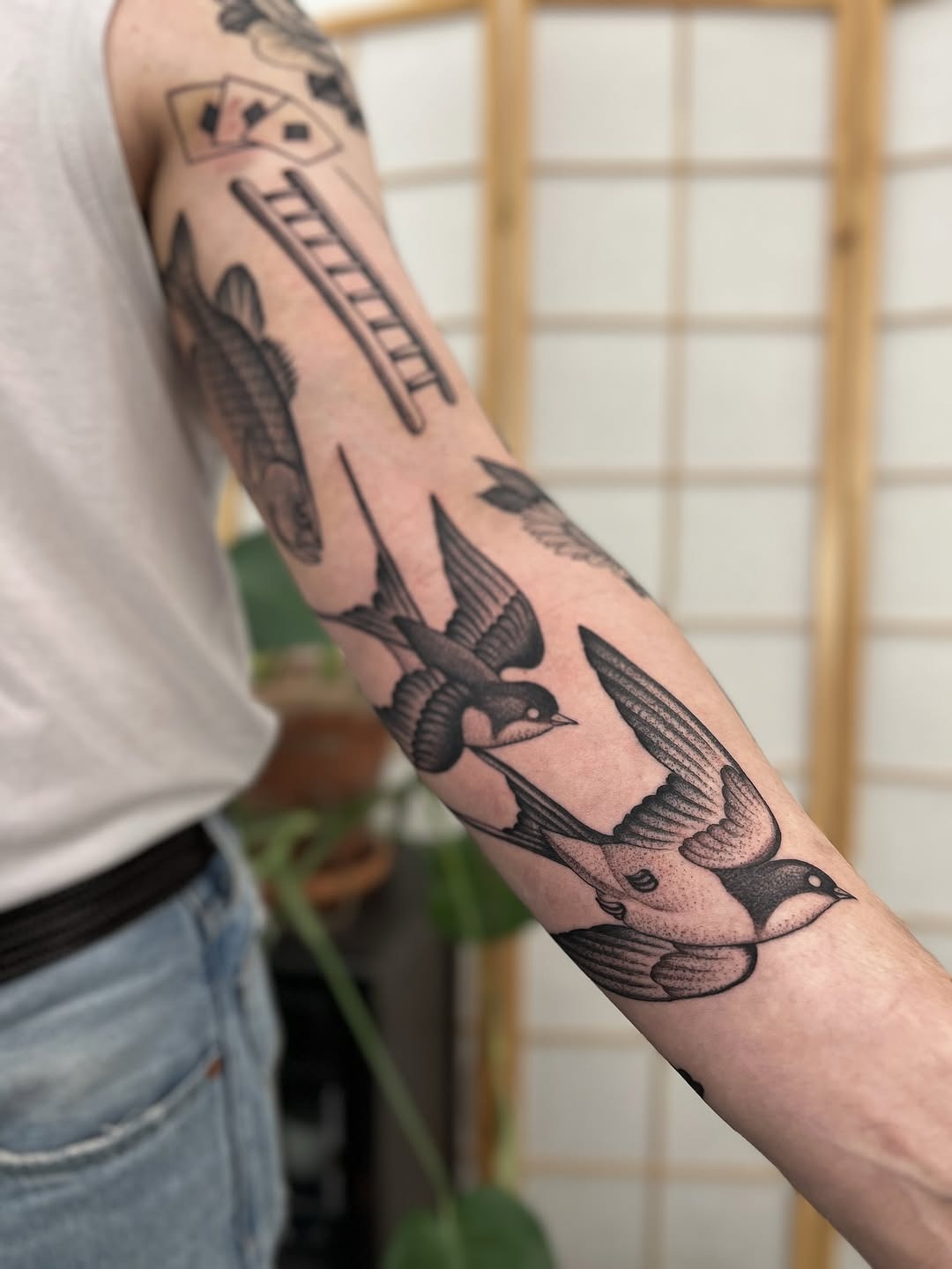 This tattoo showcases an array of beautifully executed dotwork birds in flight.
