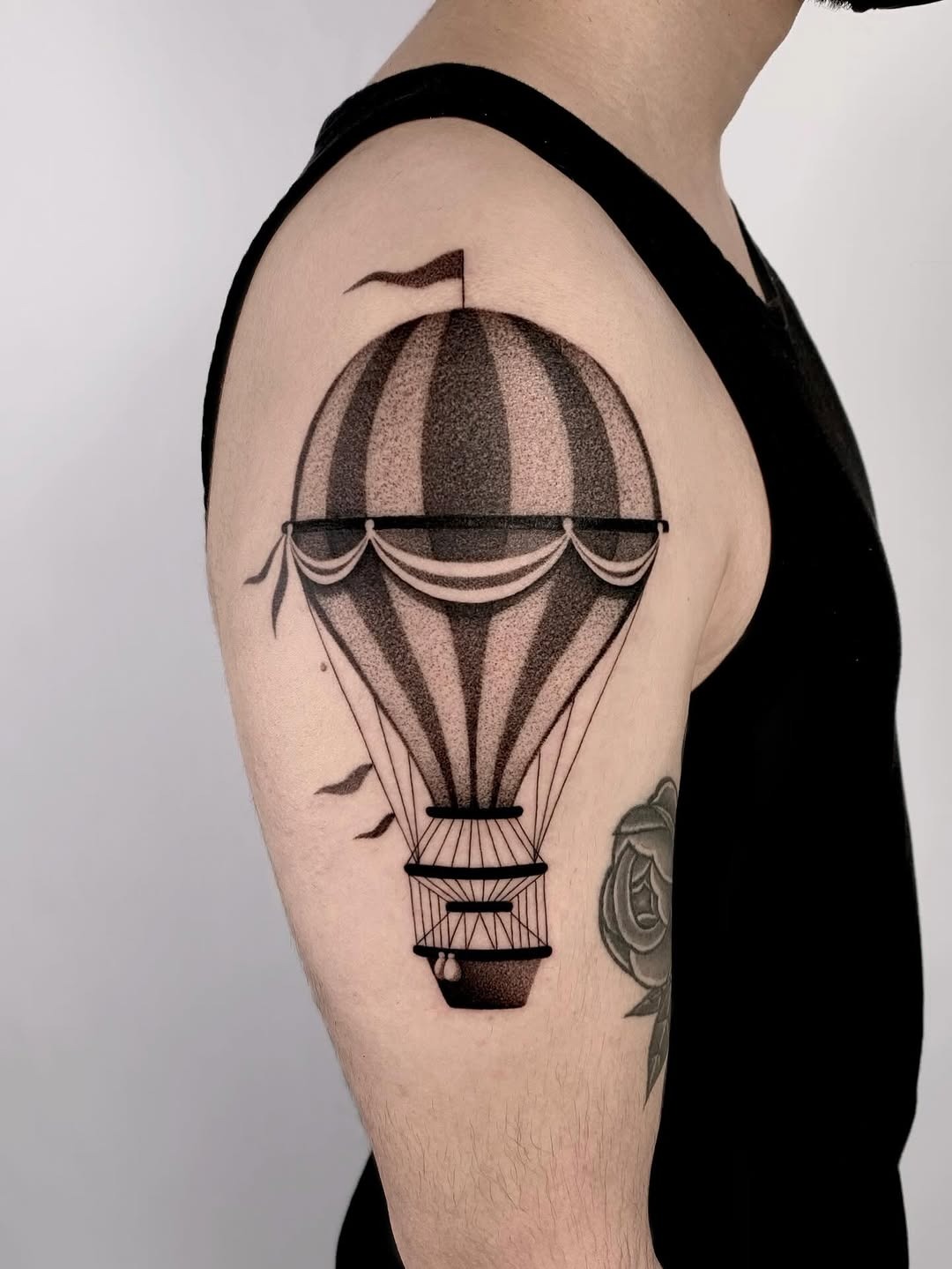 This stunning dotwork tattoo features a beautifully detailed hot air balloon soaring gracefully.
