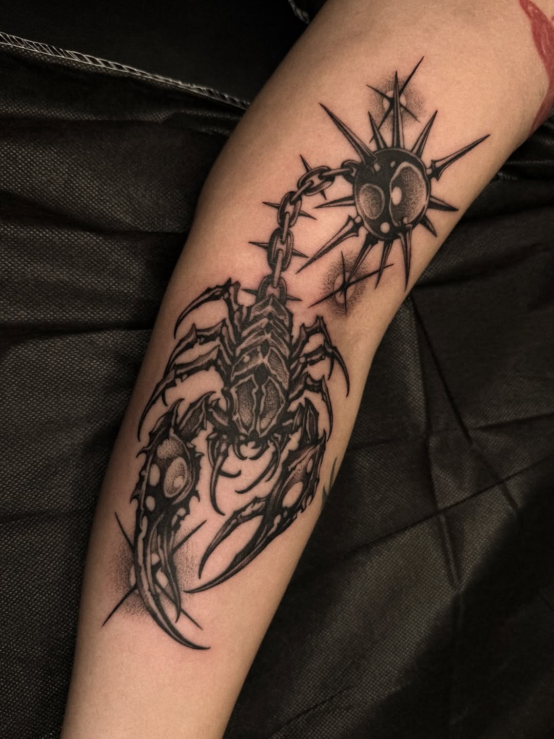 This tattoo features a striking scorpion, intricately designed in dotwork style.