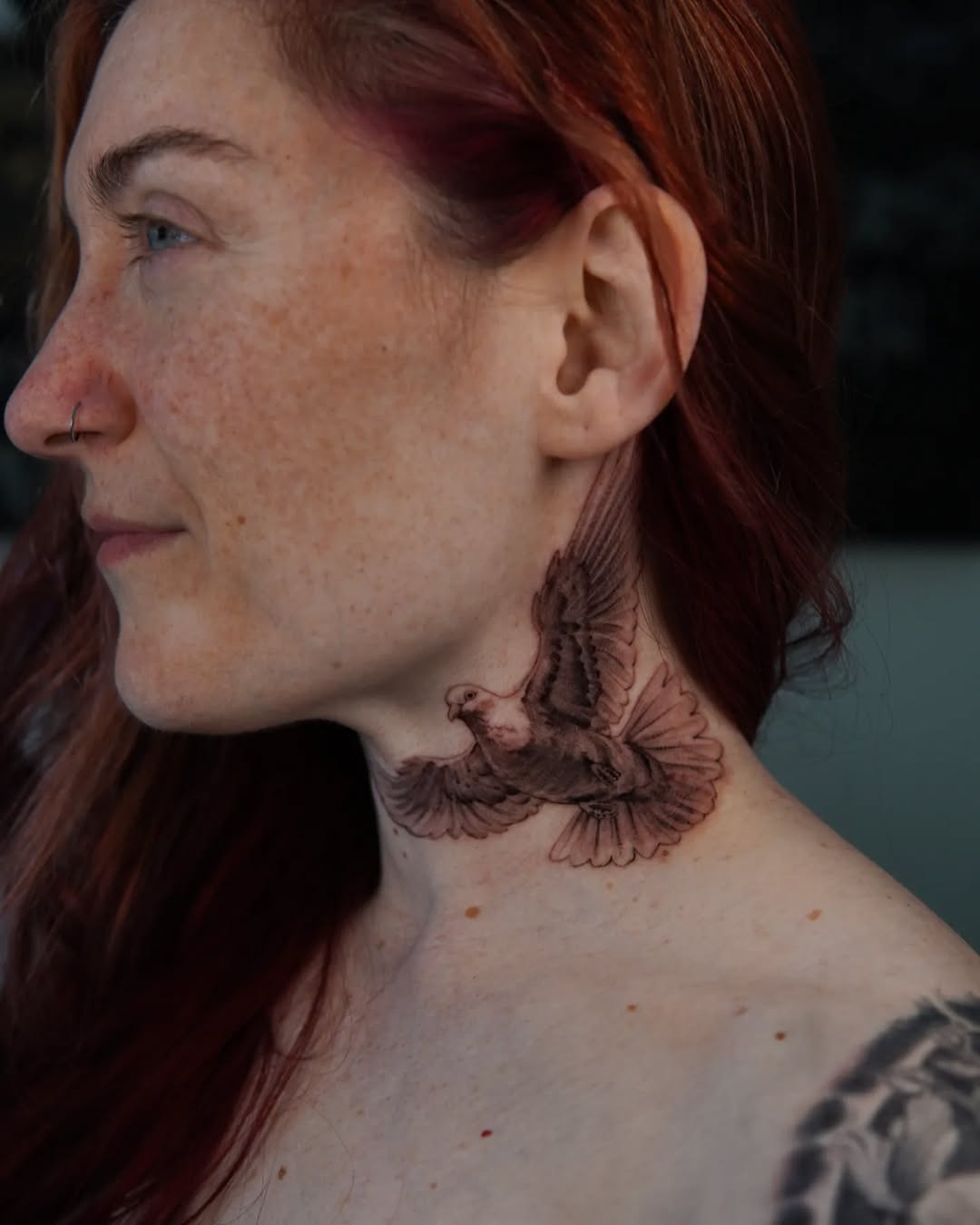 Elegant dove tattoo soaring on the neck. Tattoo Design
