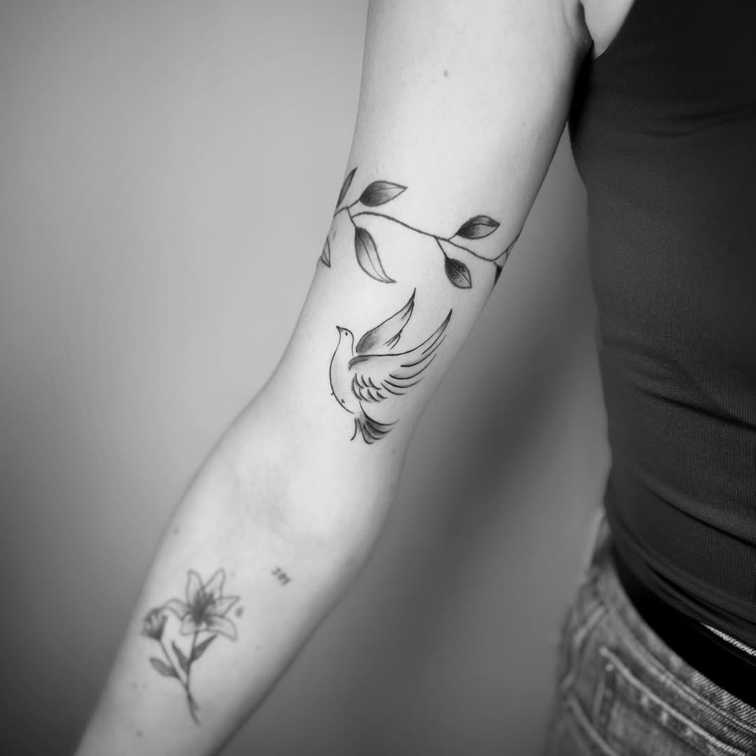 Elegant dove tattoo surrounded by flowing leaves Tattoo Design