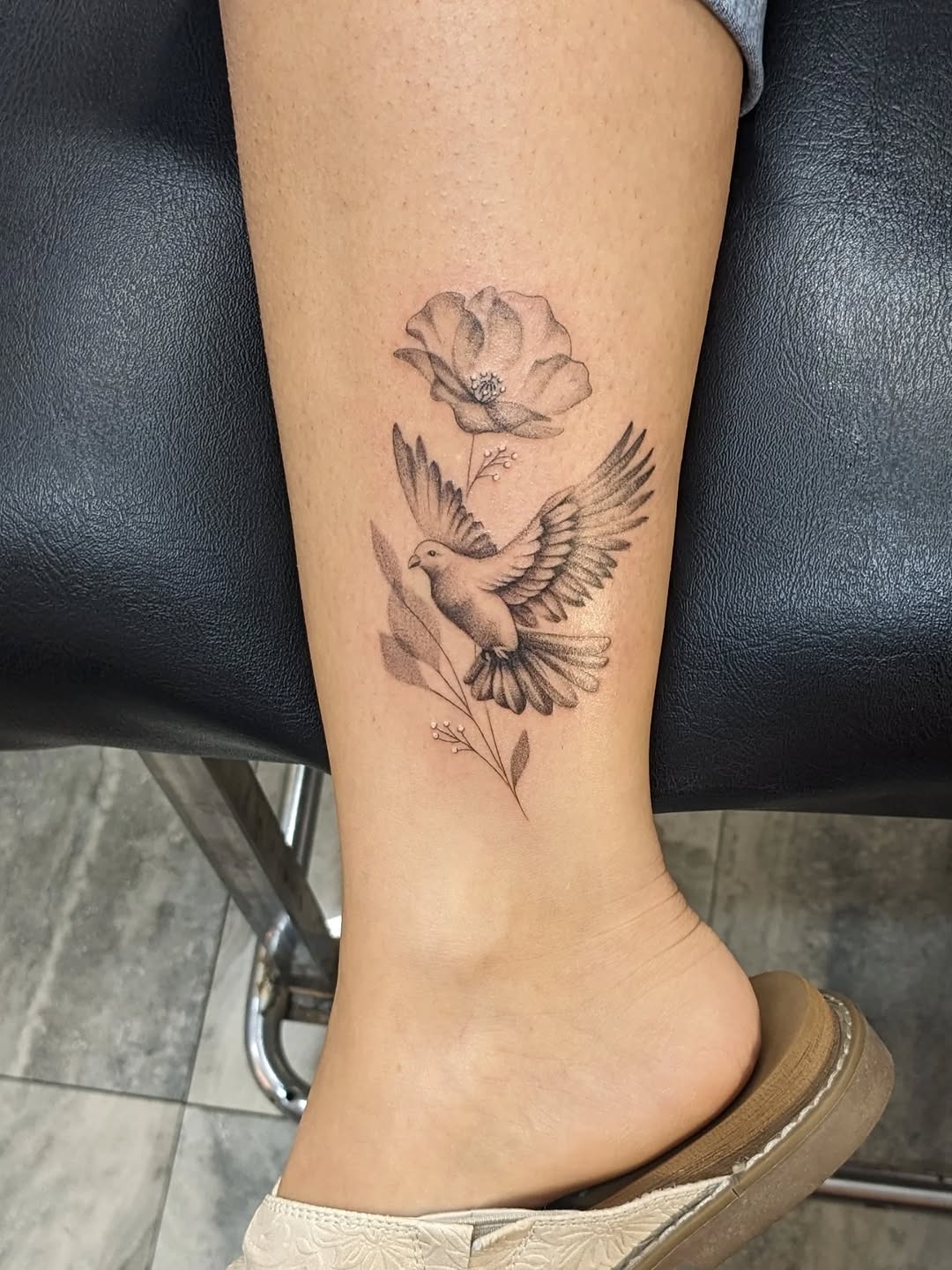 Elegant dove tattoo with floral accents Tattoo Design
