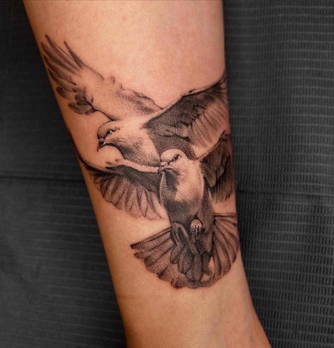 Elegant flying dove tattoo design on forearm Tattoo Design