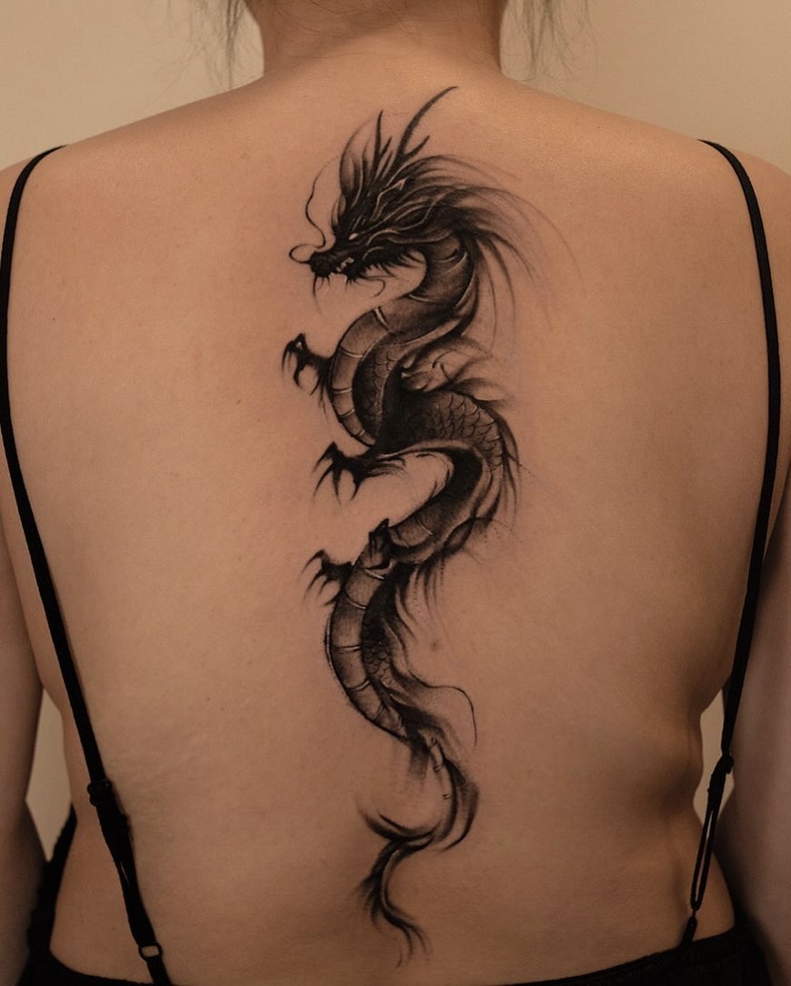 Elegant black ink dragon tattoo on the back Tattoo Design