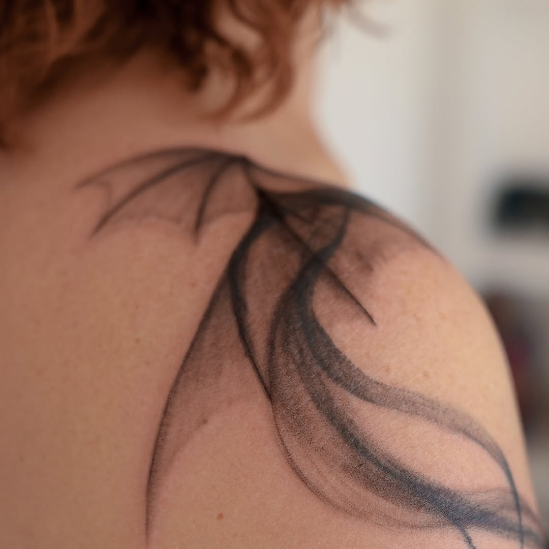 Elegant dragon silhouette tattoo on shoulder Tattoo Design
