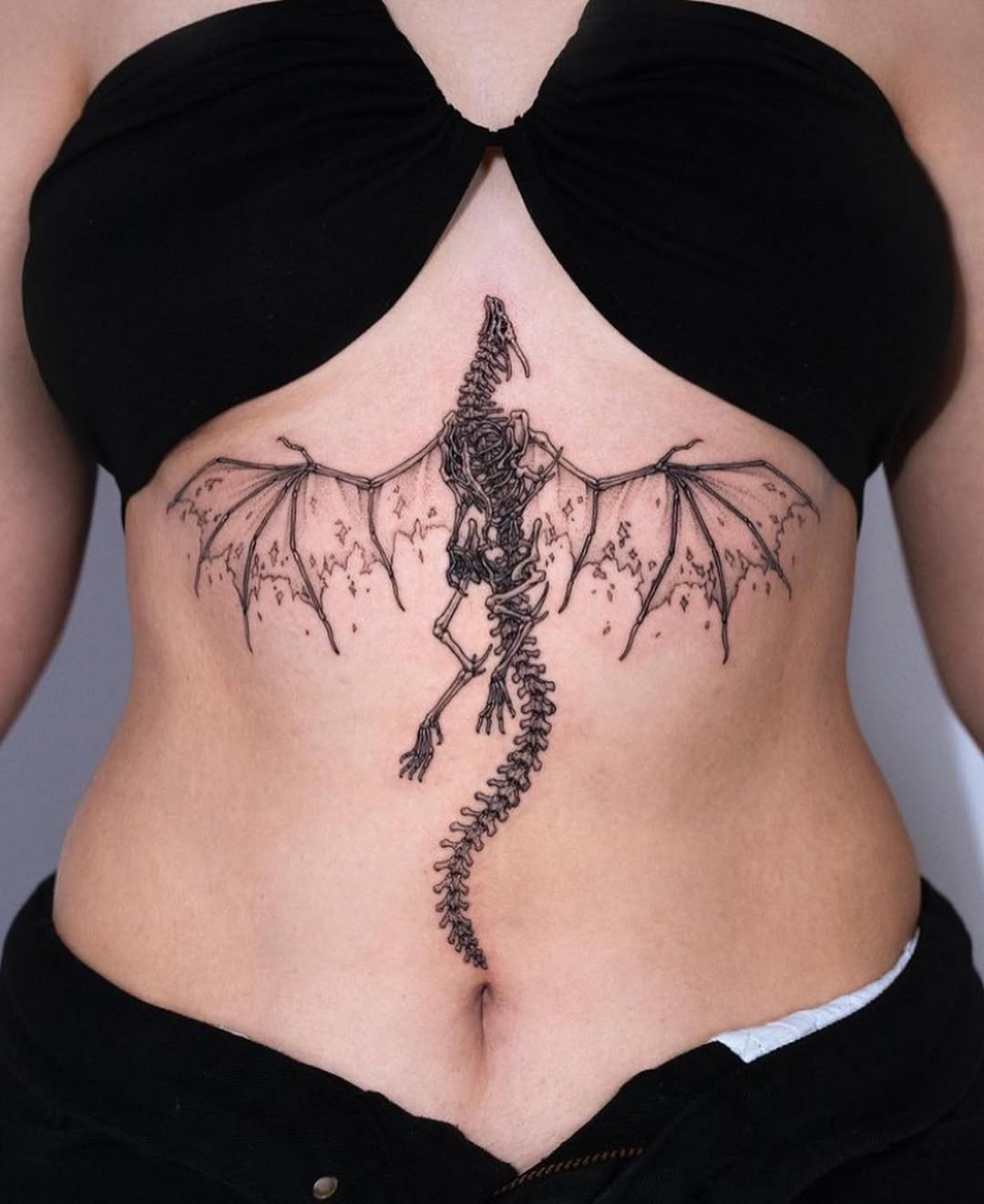 Elegantly crafted dragon skeleton tattoo design Tattoo Design