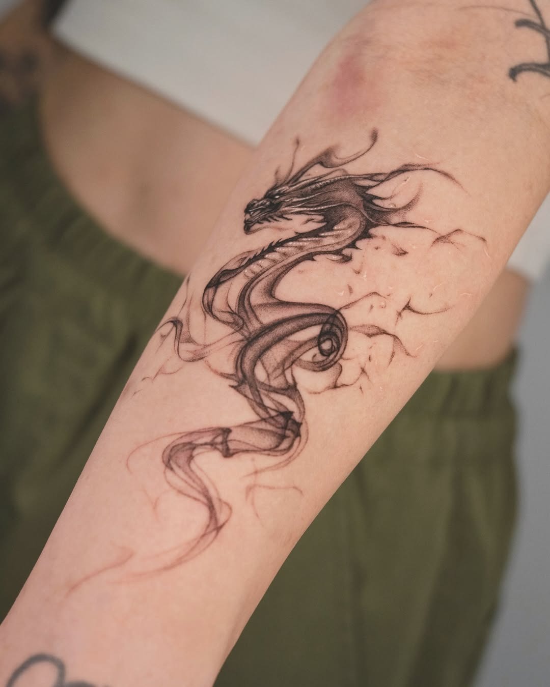 Expressive Fine Line Dragon Tattoo on Arm Tattoo Design