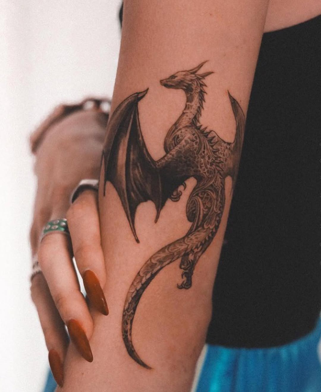 Intricate dragon tattoo on a woman’s arm Tattoo Design