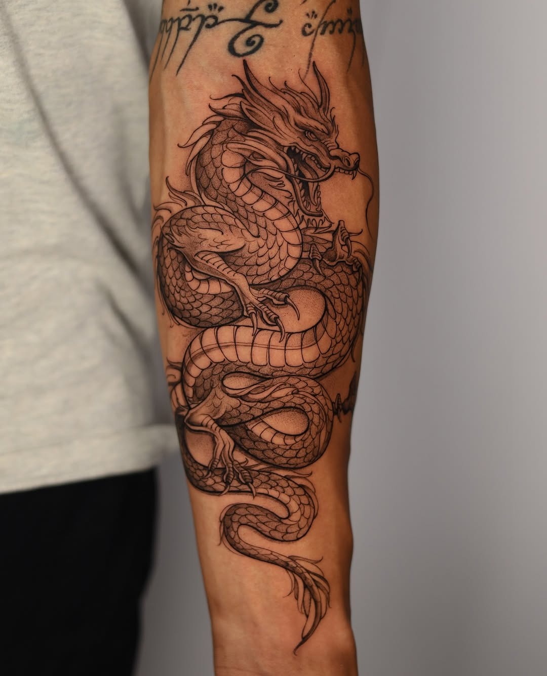 Intricate Dragon Tattoo with Fierce Detailing Tattoo Design