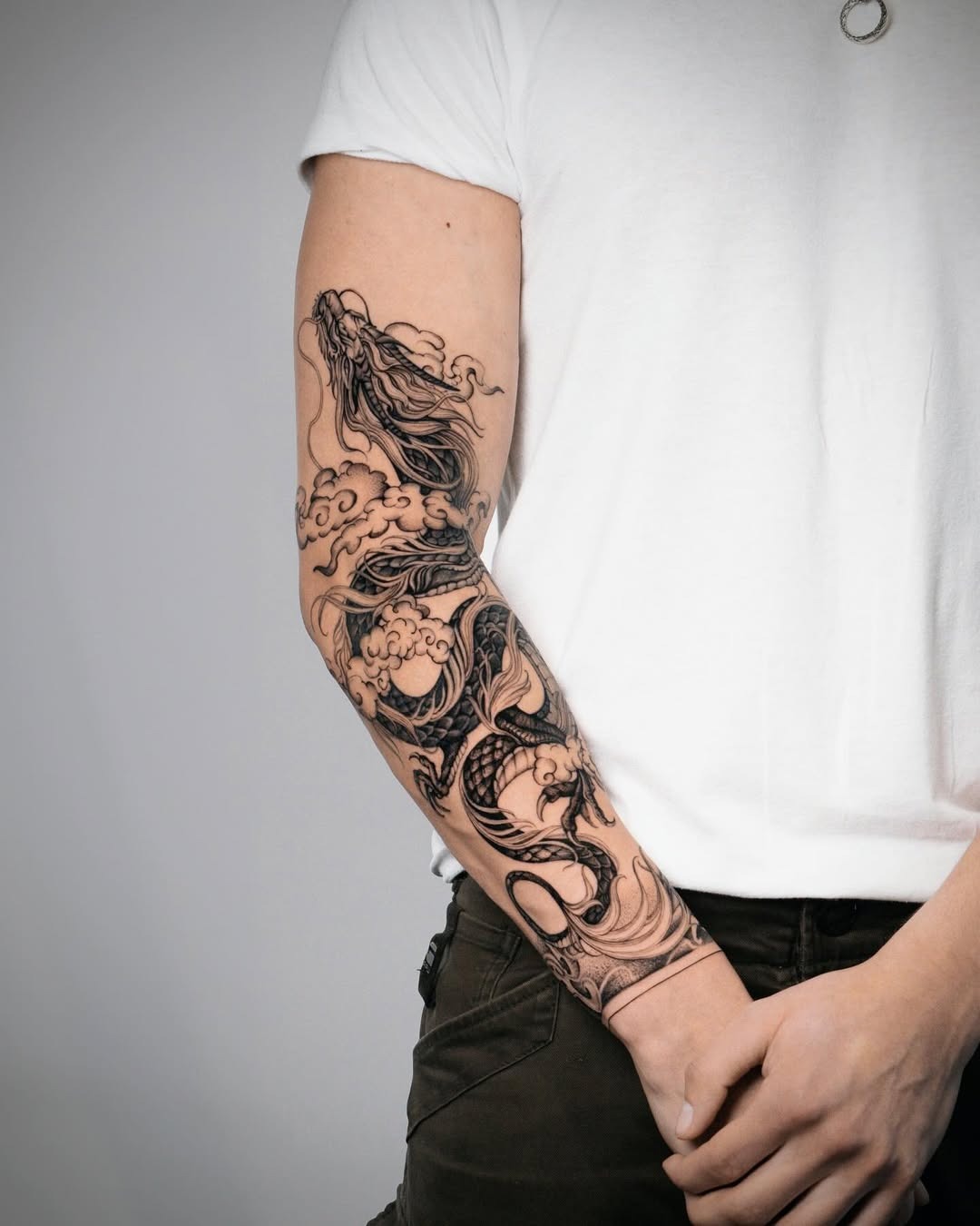 Intricate dragon tattoo with waves and clouds Tattoo Design