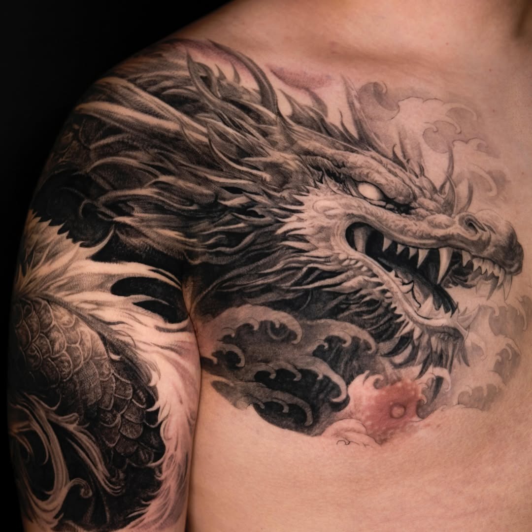 Stunning dragon shoulder tattoo in grayscale ink Tattoo Design