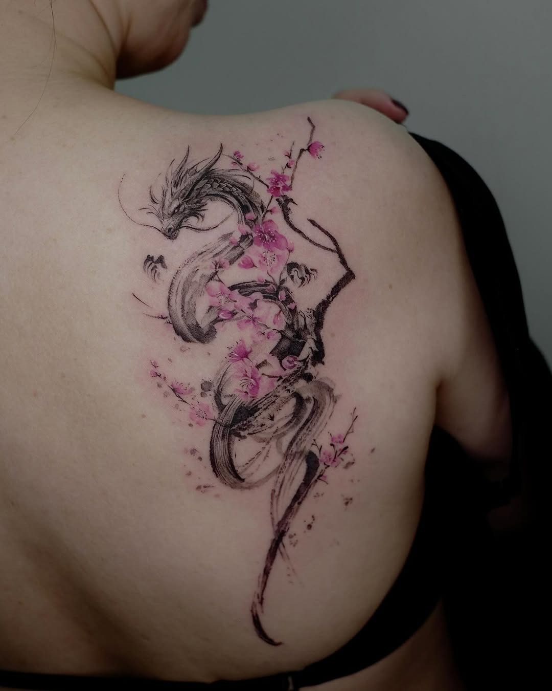 Stunning dragon tattoo with delicate cherry blossoms Tattoo Design