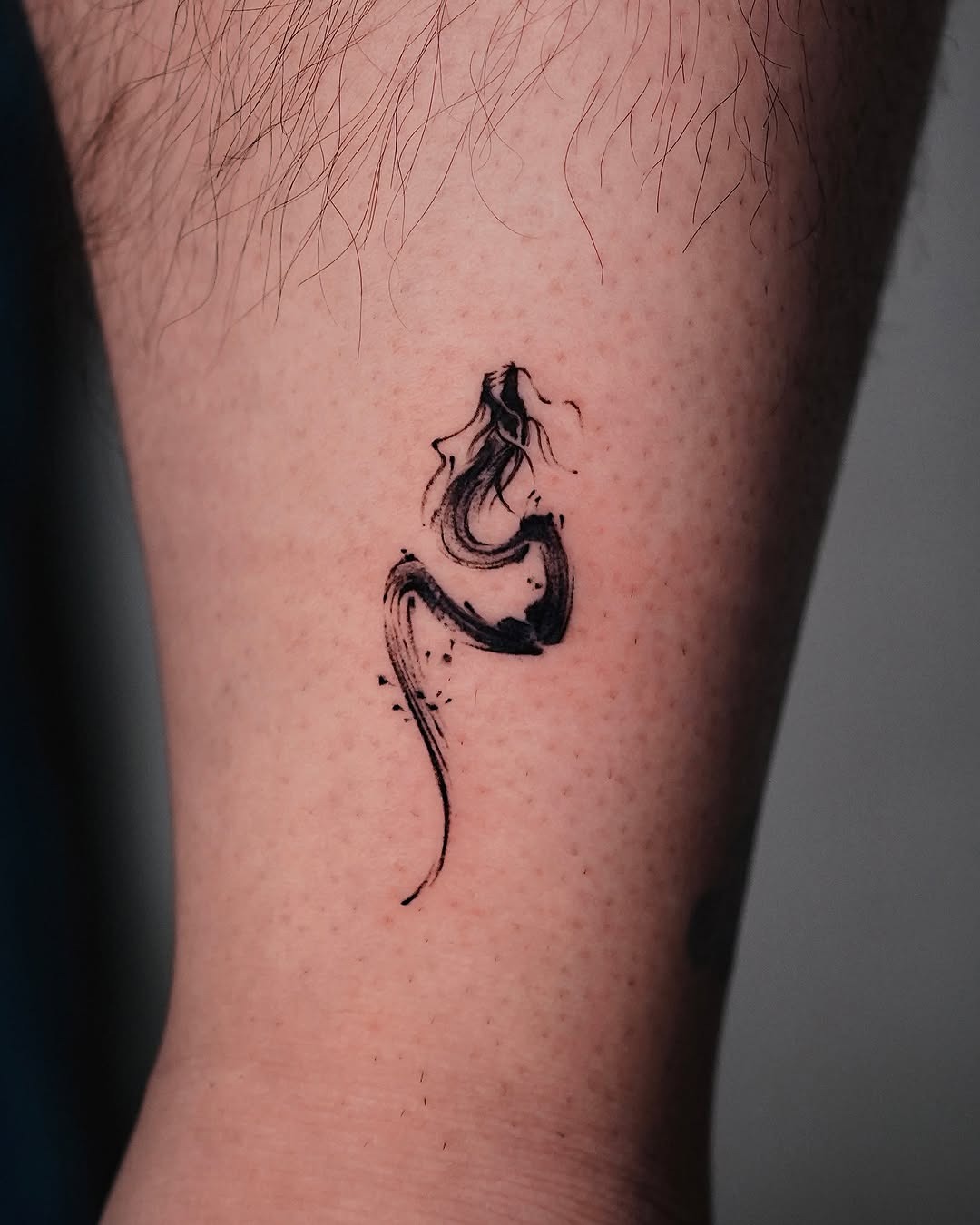 Stunning minimalist dragon tattoo on the arm Tattoo Design