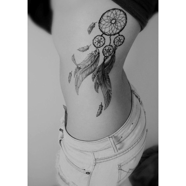Elegant dreamcatcher tattoo on the rib area Tattoo Design