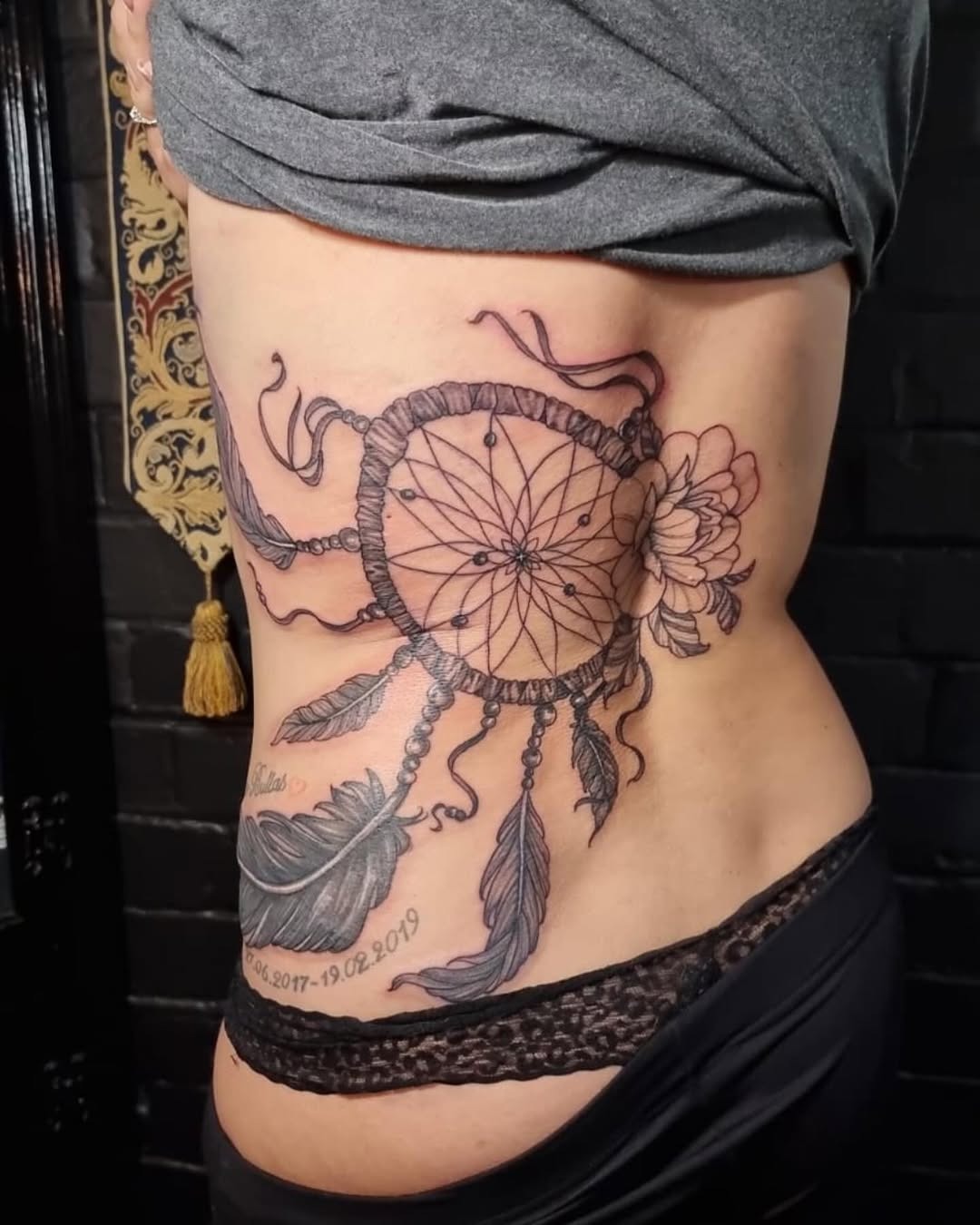 Elegant dreamcatcher tattoo with delicate floral designs Tattoo Design