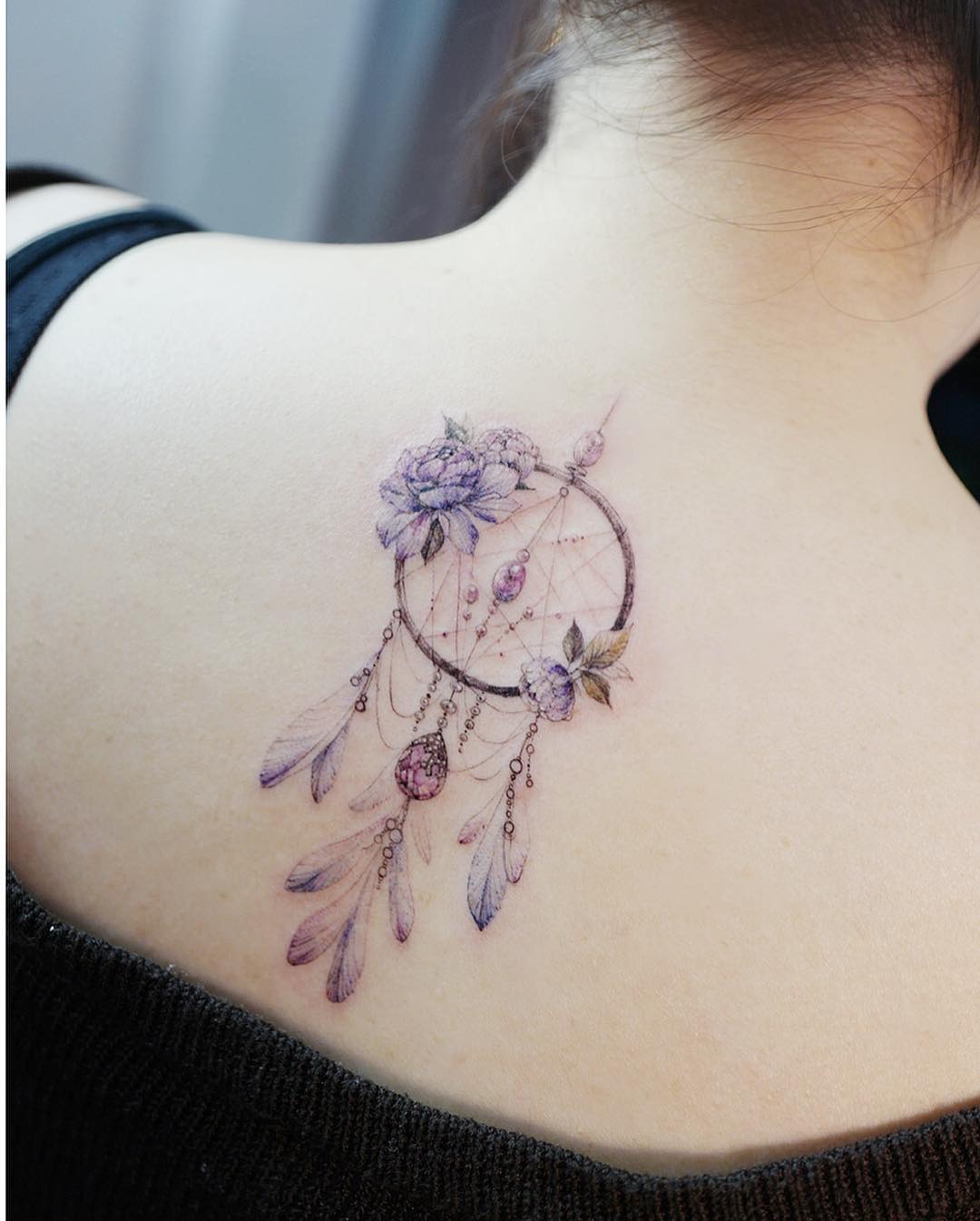 Elegant dreamcatcher tattoo with floral elements Tattoo Design