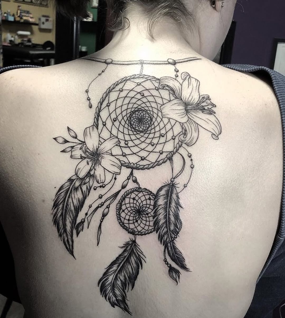 Elegantly crafted dreamcatcher tattoo with flowers Tattoo Design