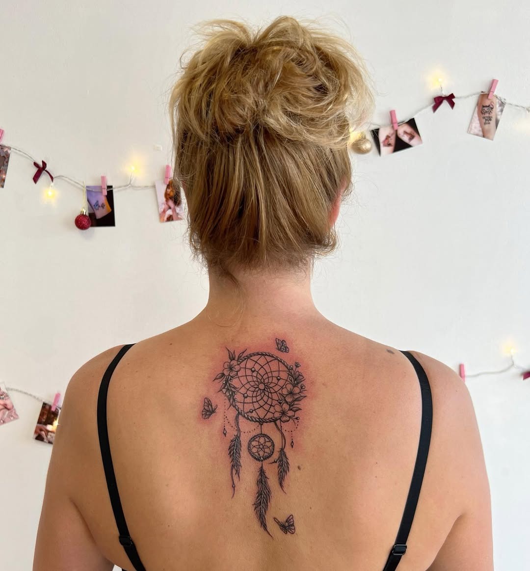 Intricate dreamcatcher tattoo with floral accents Tattoo Design