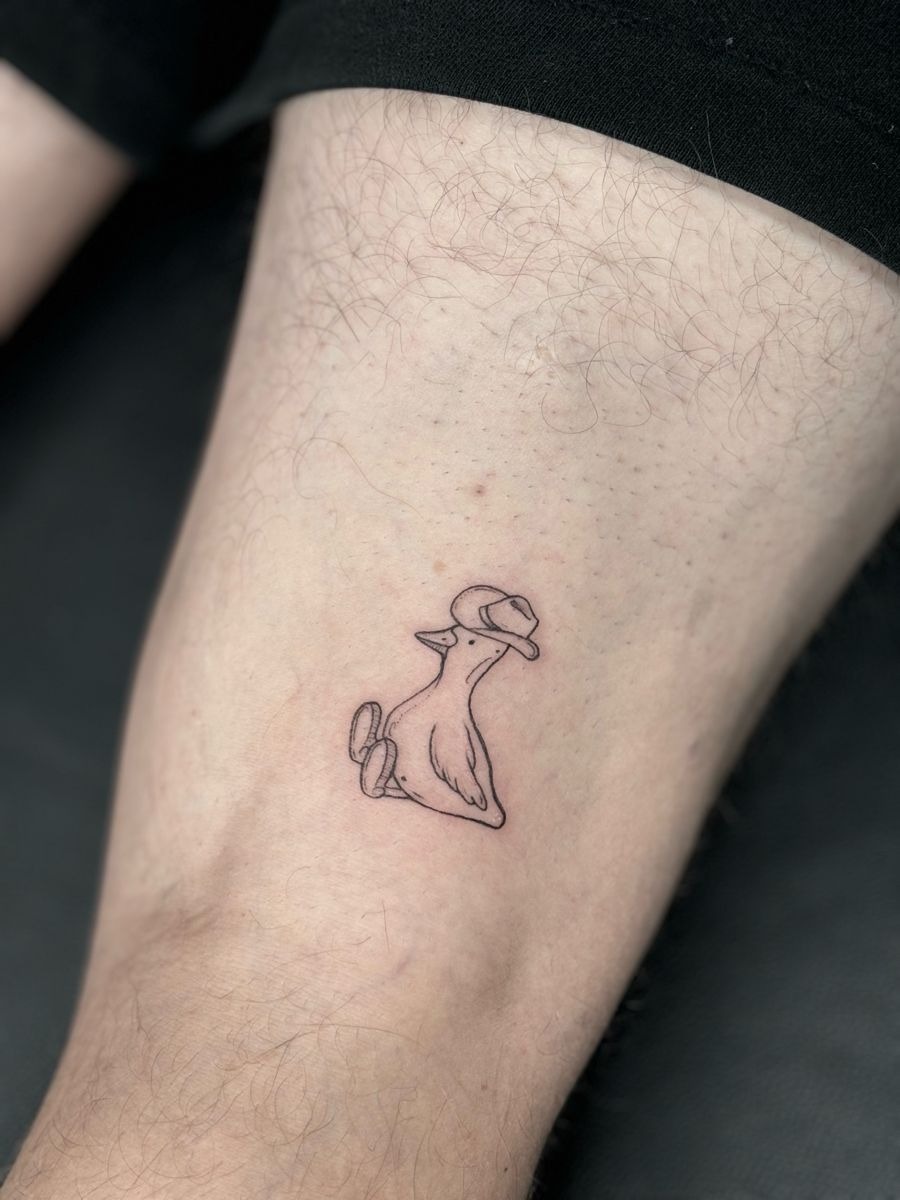 Tiny Minimalist Cowboy Duck Tattoo Design