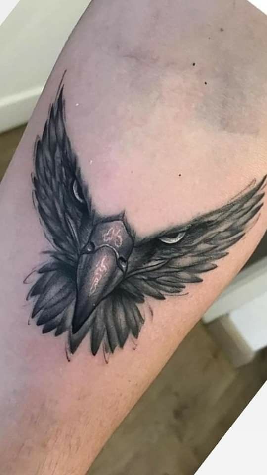 Intense Eagle Head with Outstretched Wings Tattoo Design