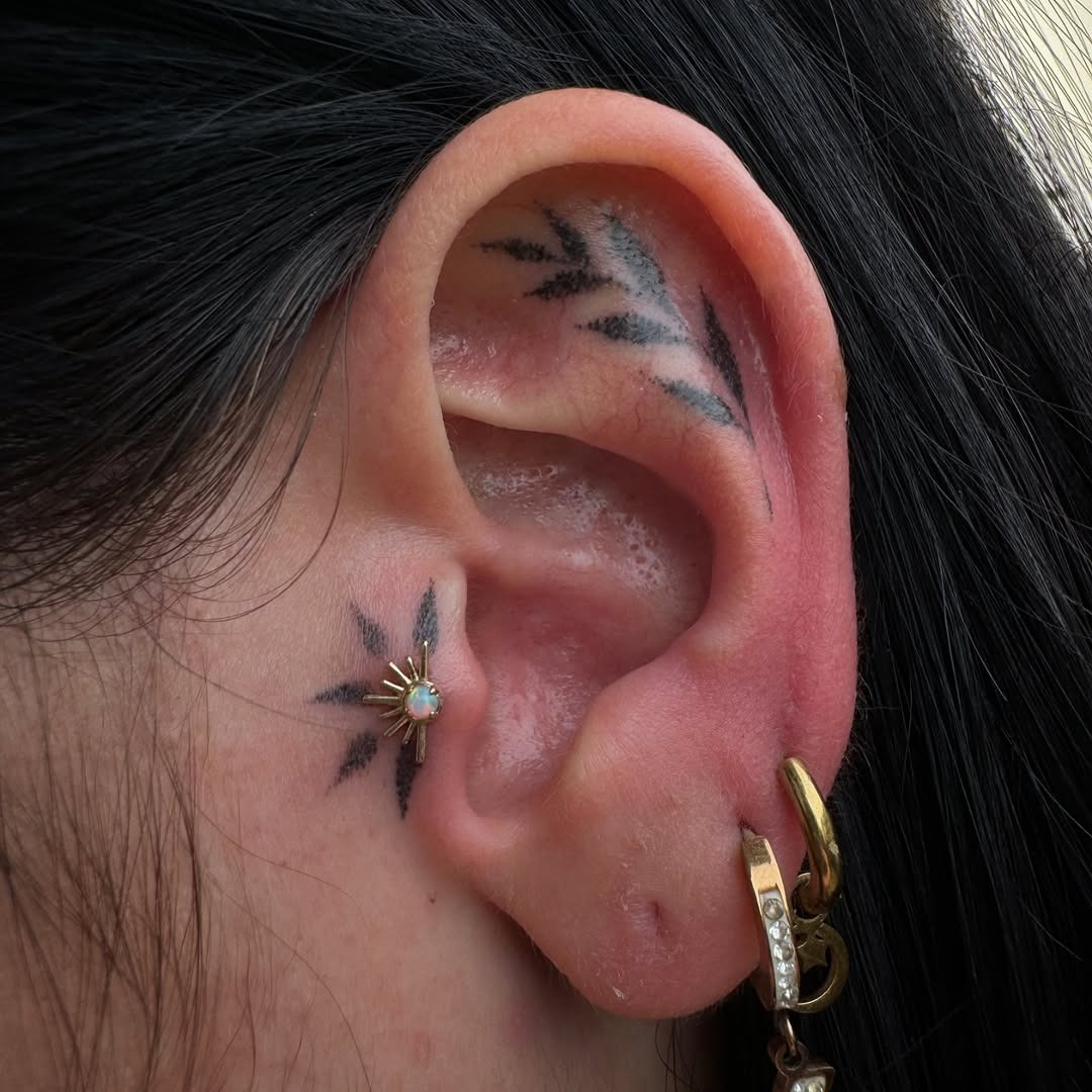Chic ear tattoos with floral and leaf designs Tattoo Design