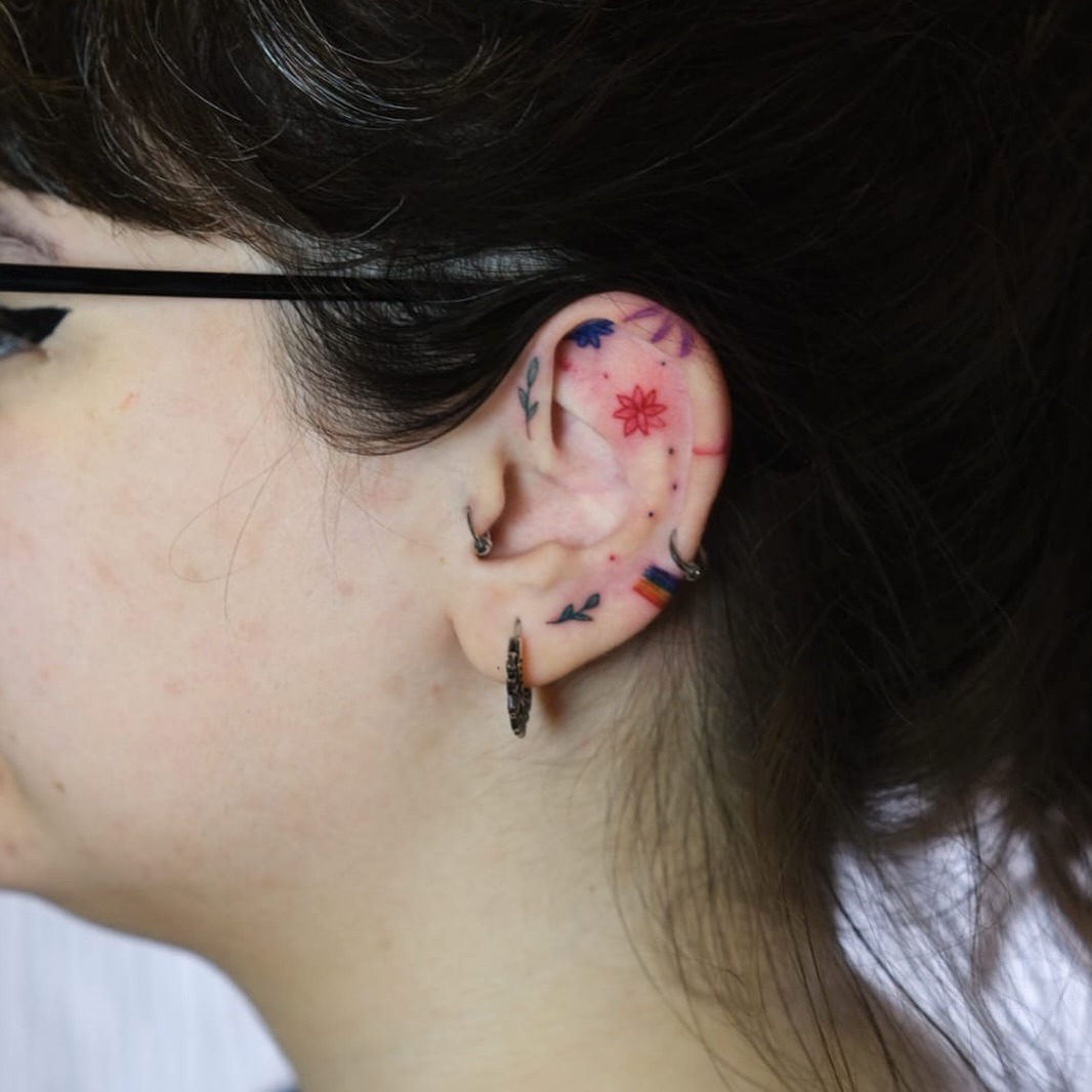 Colorful and intricate ear tattoo artistry Tattoo Design