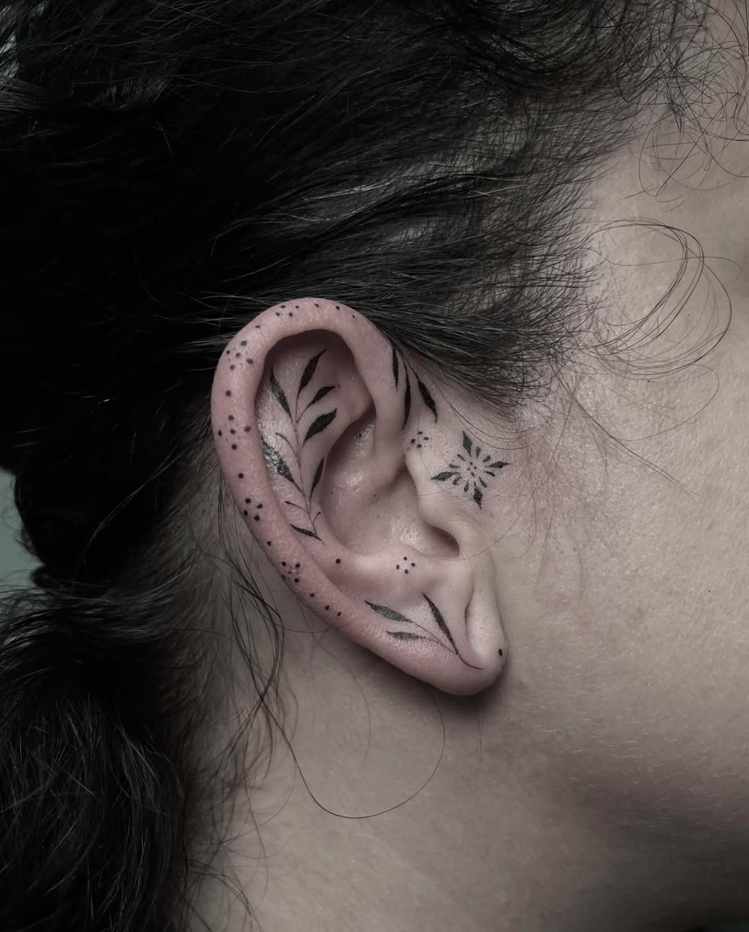 Delicate floral ear tattoos showcasing nature's beauty Tattoo Design