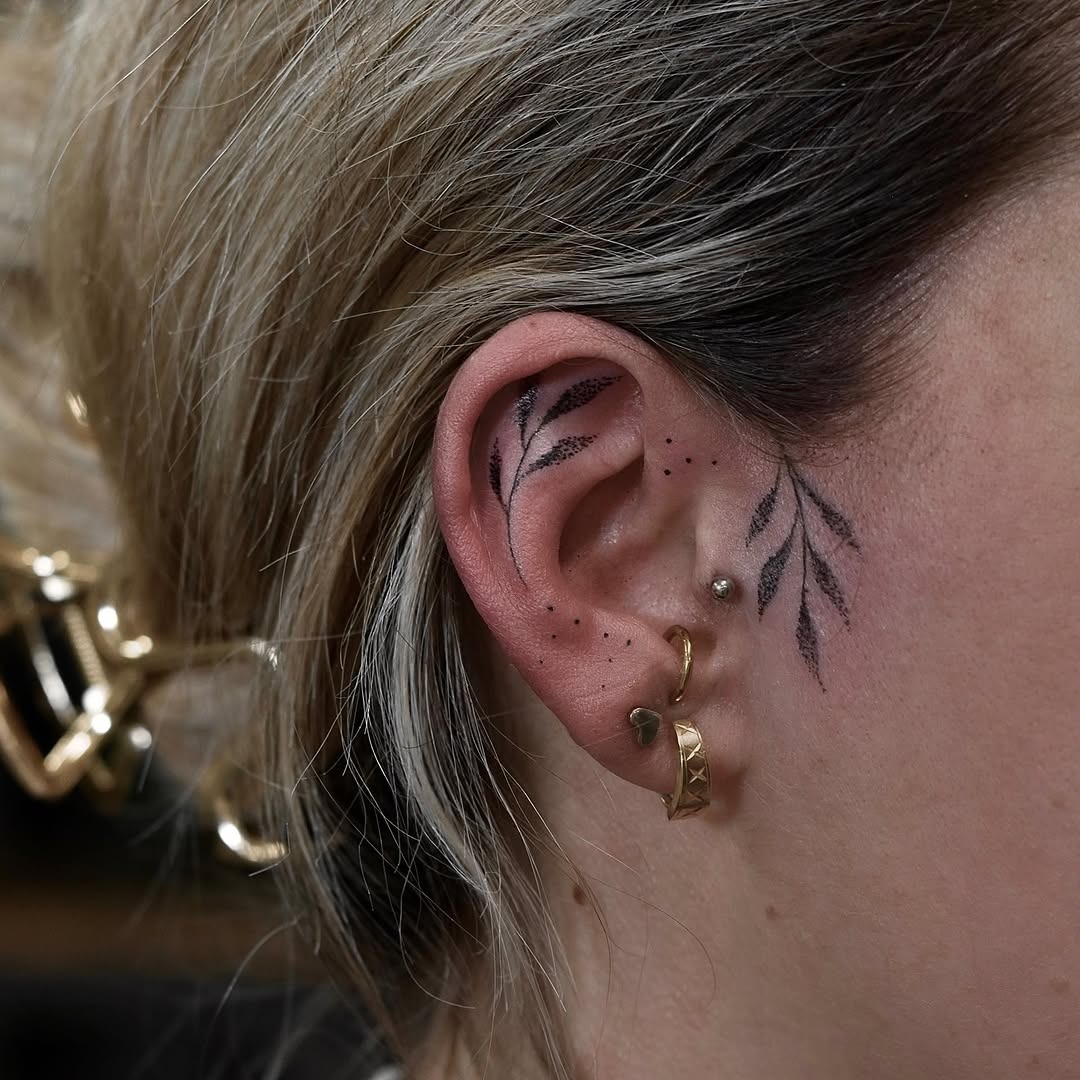Delicate leaves elegantly accentuating the ear. Tattoo Design