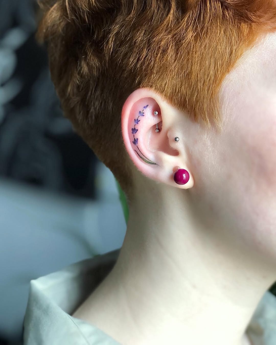 Elegant floral design adorning the ear Tattoo Design