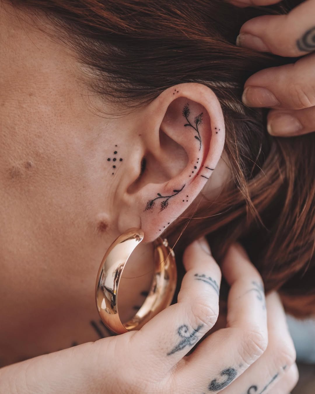 Elegant Floral Designs Adorning the Ear Tattoo Design