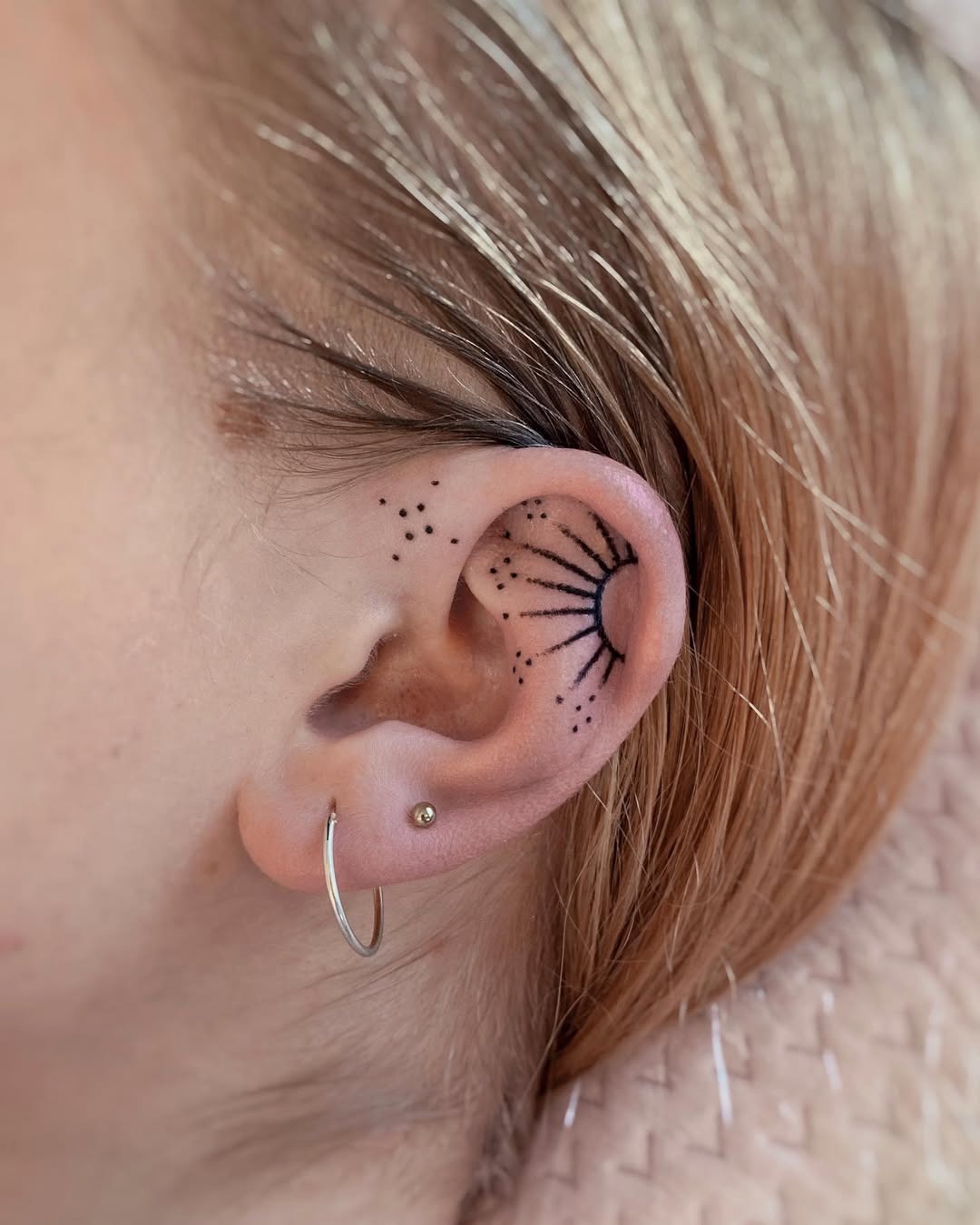 Minimalist sunburst tattoo with dotted accents Tattoo Design