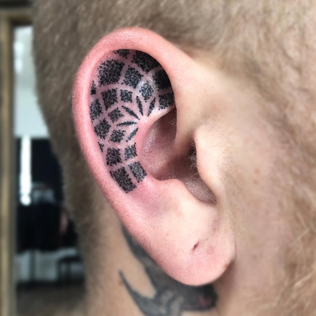 Unique geometric ear tattoo design in black ink Tattoo Design