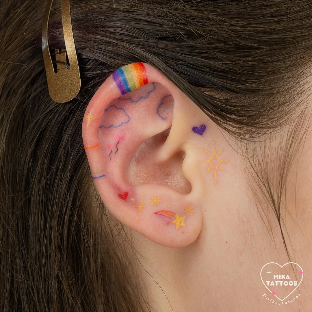 Vibrant ear tattoos with playful motifs Tattoo Design
