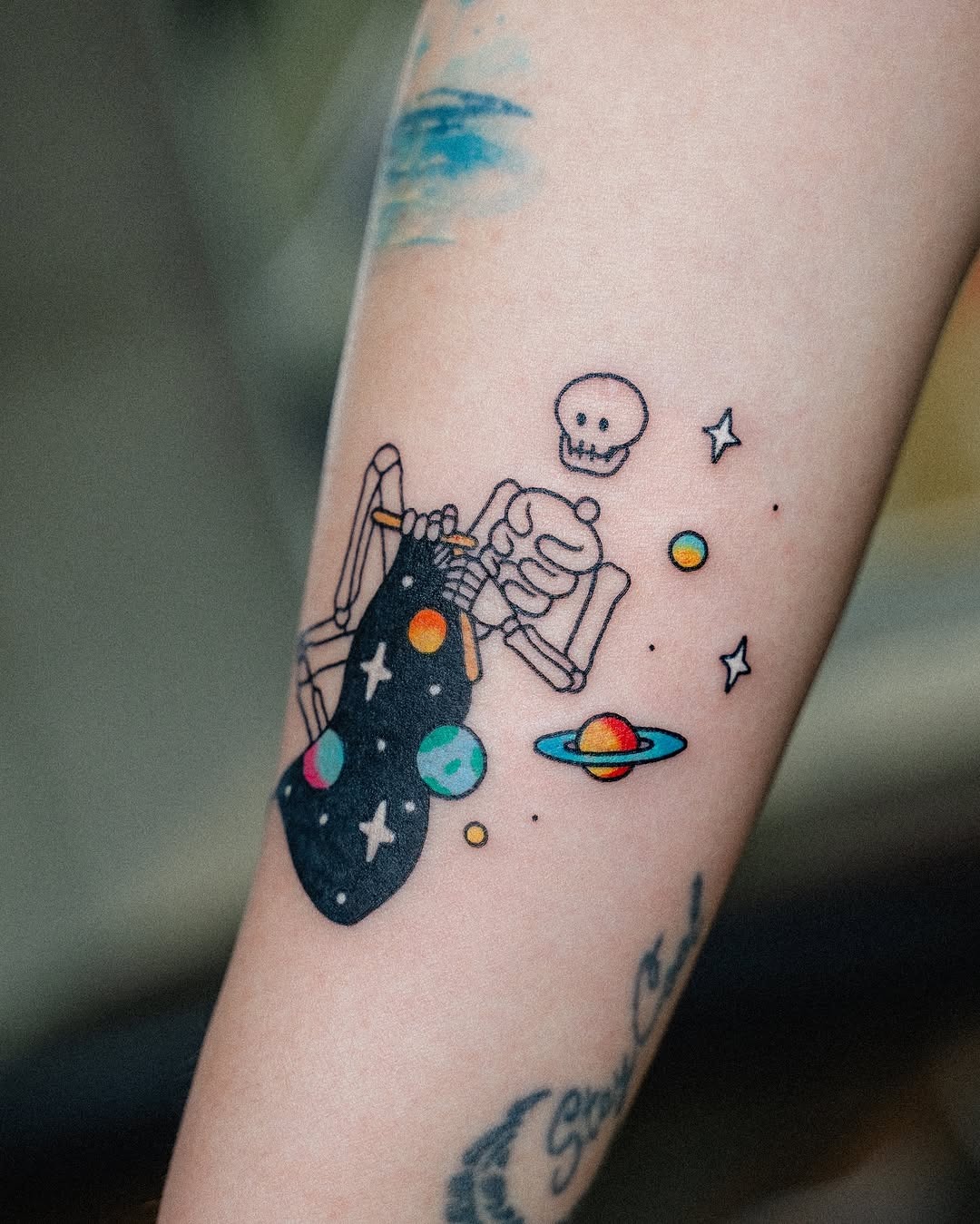 Cosmic skeleton lounging among celestial bodies Tattoo Design