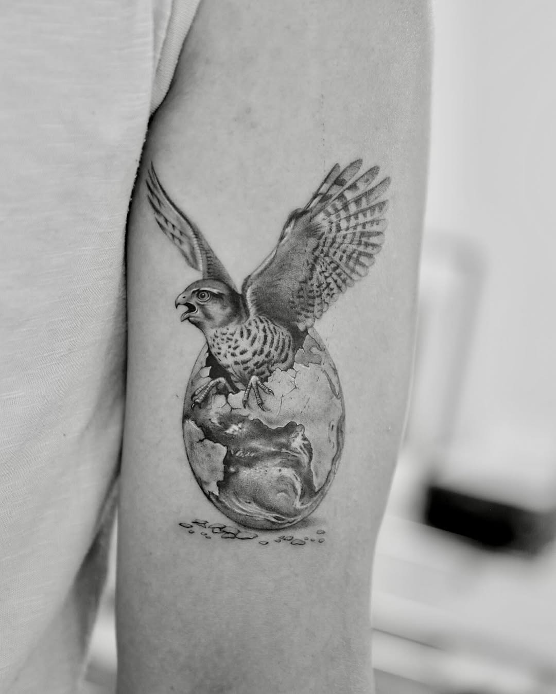 Majestic falcon soaring over the earth tattoo Tattoo Design