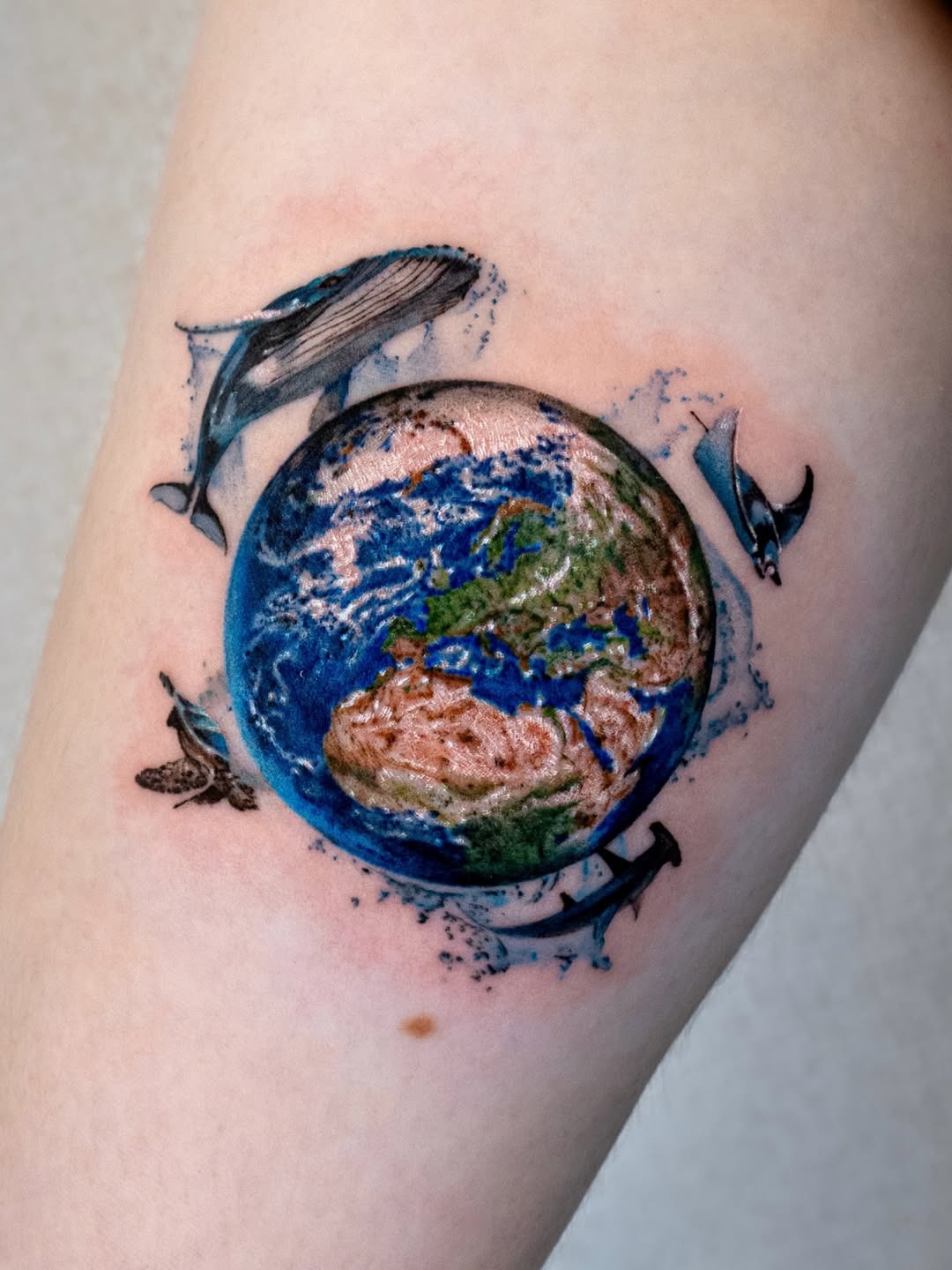 Vibrant Earth Tattoo Surrounded by Marine Life Tattoo Design