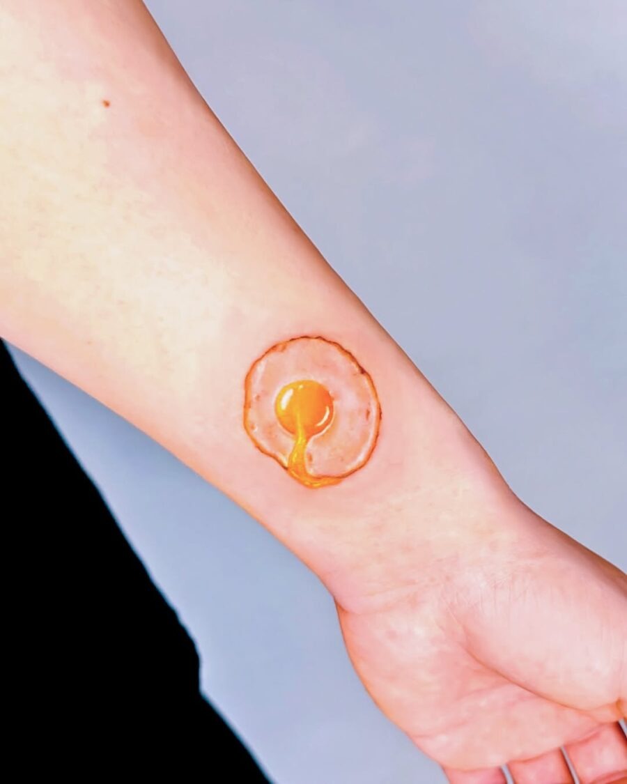 This egg tattoo showcases a, realistic design.